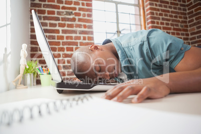 Casual businessman sleeping at his desk