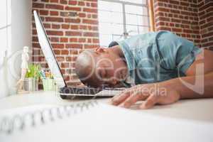 Casual businessman sleeping at his desk