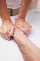 Manicurist massaging a customers hand