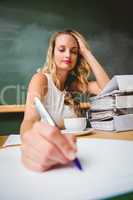 Beautiful businesswoman writing document at desk