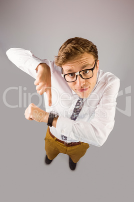 Geeky businessman pointing to watch