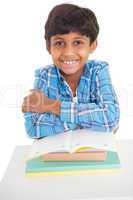 Cute elementary pupil smiling at camera