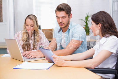 Business people using digital tablet and laptop in meeting