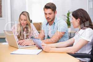 Business people using digital tablet and laptop in meeting