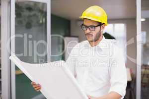 Casual architect studying his blueprints