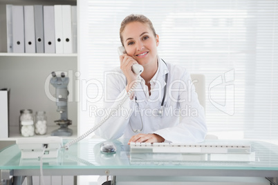 Smiling doctor on her phone