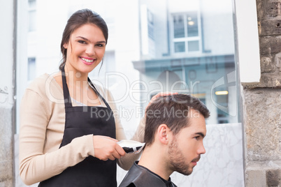 Handsome man getting his hair trimmed