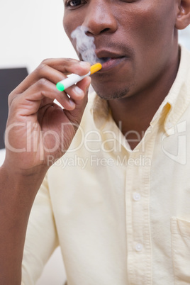 Businessman smoking an electronic cigarette