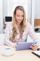 Blonde businesswoman using her digital tablet