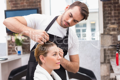 Handsome hair stylist with client