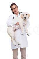 Smiling veterinarian with a cute dog in her arms