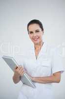 Smiling doctor holding a laptop