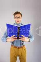 Geeky businessman reading a book