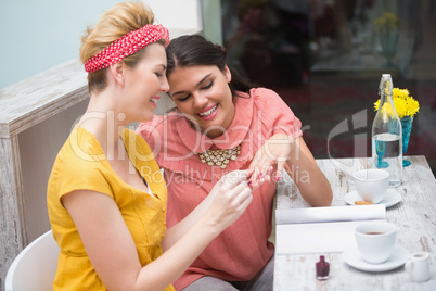 Pretty friends painting their nails