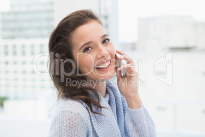 Pretty brunette on the phone by the window