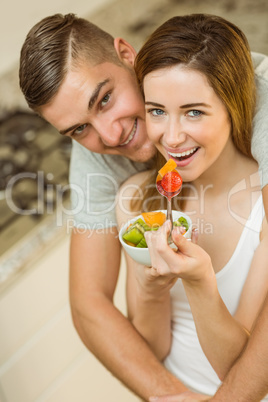 Couple eating fruit salad at breakfast