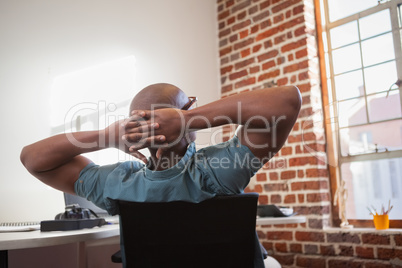 Casual businessman leaning back in chair
