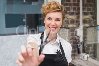 Confident hairdresser smiling at camera