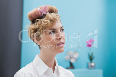 Customer sitting with curlers in hair
