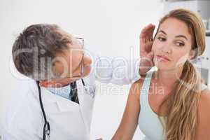 Doctor examining patients face