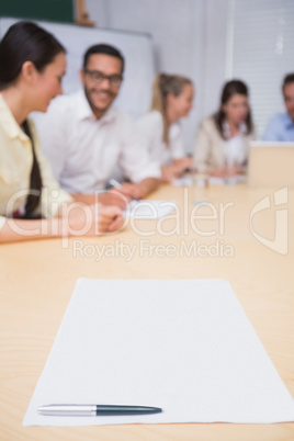 Blank page on the table in front of the business team