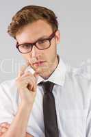 Young businessman thinking looking at camera