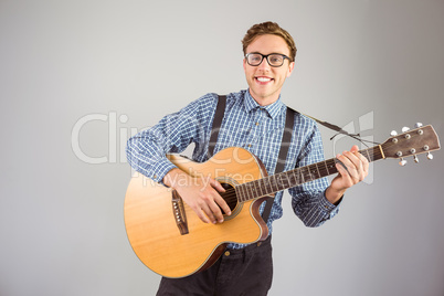 Geeky hipster playing the guitar