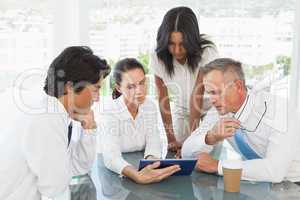 Business team looking at a tablet