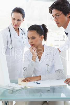 Doctors looking at a computer monitor