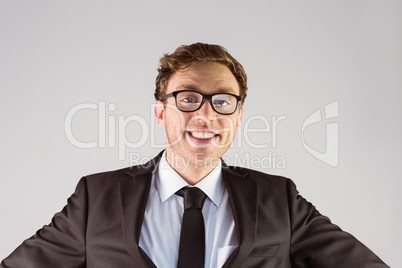 Young geeky businessman smiling at camera