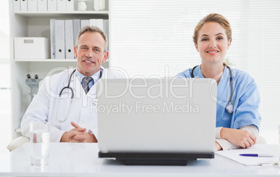 Doctor and nurse smiling at the camera Doctor and nurse smiling at the camera