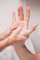 Manicurist massaging a customers hand