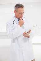 Focused doctor looking over medical notes