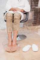 Customer soaking feet at salon