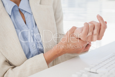 Woman massaging her sore wrist