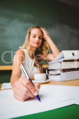 Beautiful businesswoman writing document at desk