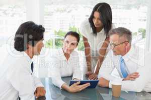 Business team looking at a tablet