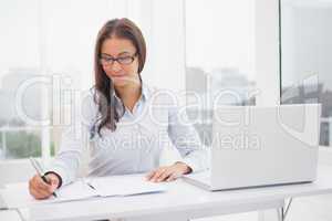 Smiling businesswoman working at her desk