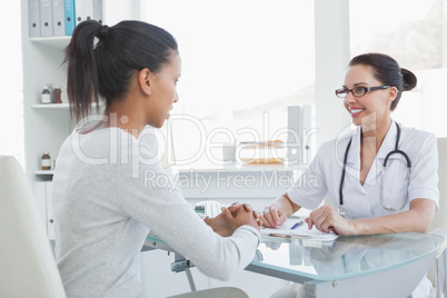 Smiling doctor talking with a patient