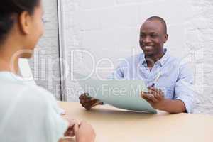 Smiling businessman holding folder during an interview
