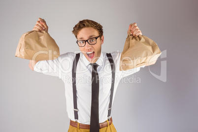 Geeky businessman holding paper bags