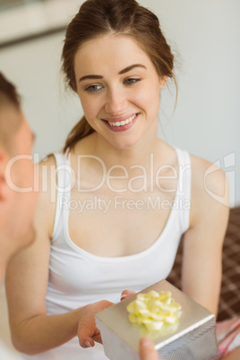 Man giving his pretty girlfriend a gift