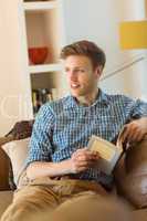 Young man reading on his couch