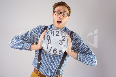 Geeky businessman holding a clock Geeky businessman holding a clock