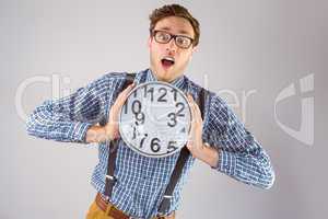 Geeky businessman holding a clock