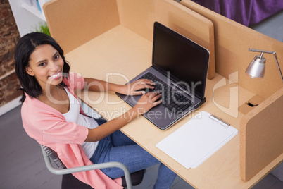 Smiling woman typing on her computer