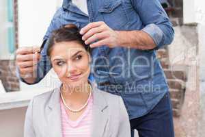 Pretty brunette getting her hair styled