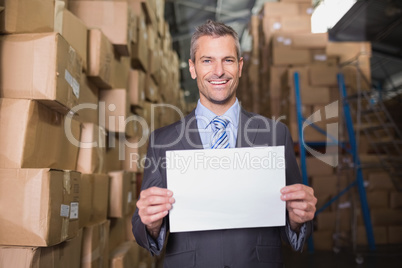 Manager holding blank board in warehouse