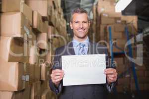 Manager holding blank board in warehouse
