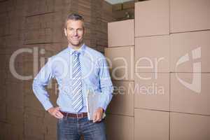 Portrait of manager holding clipboard in warehouse